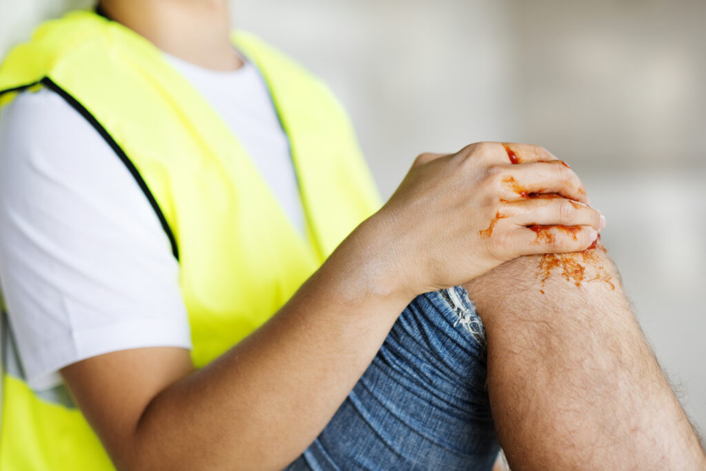 construction worker holding his knee after an injury