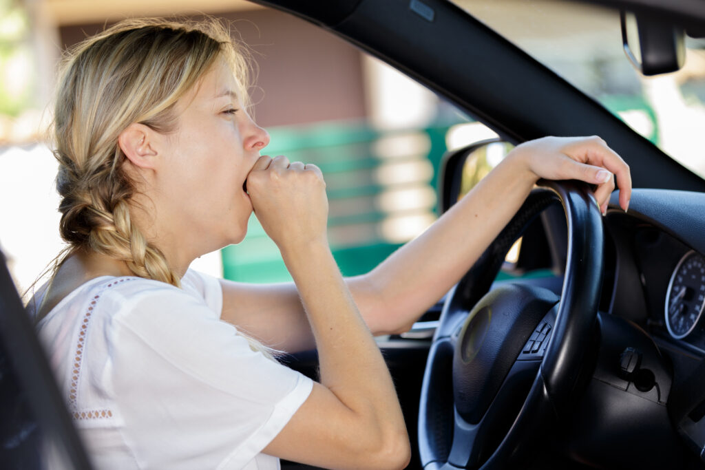 A woman driving while sleep deprived and drowsy.