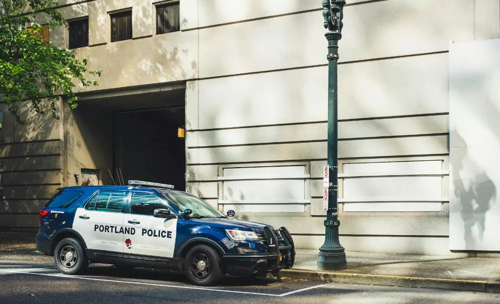 A stationary Portland, OR police car.