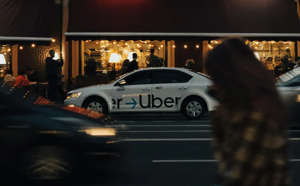 An Uber car in traffic.