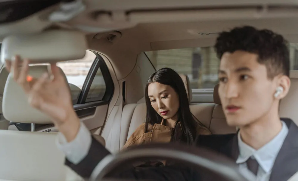 A passenger in the backseat of a rideshare vehicle.