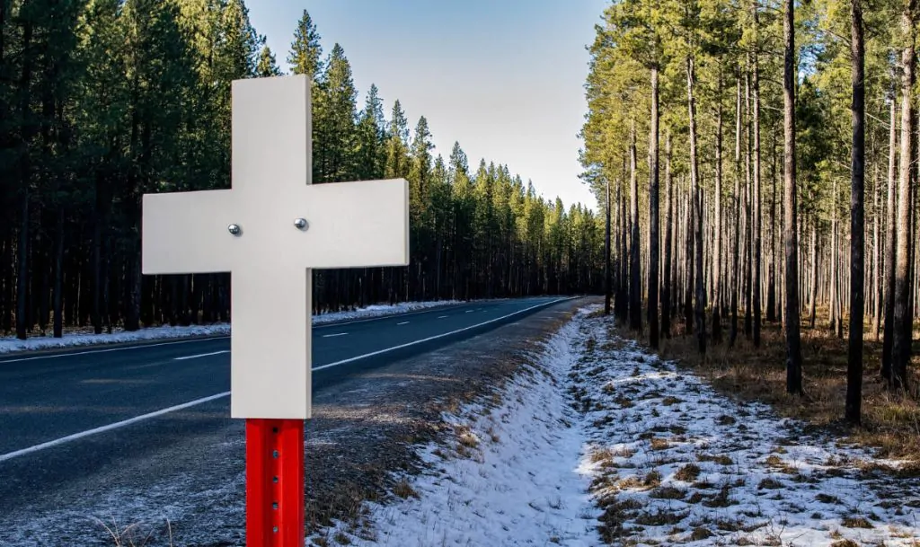 A roadway fatality cross.